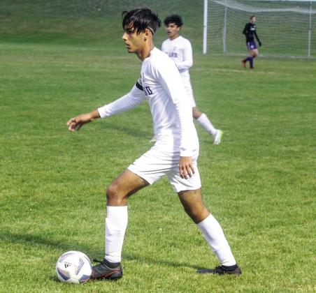 _ Agustin Creamer dribbles before passing to a teammate during a Northwest Conference soccer match last fall. Enterprise photo by Brian Freiberger