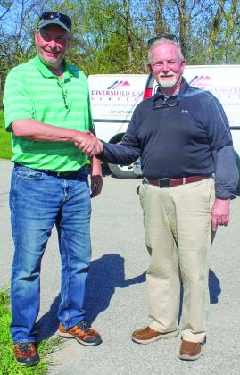 Mike Oprish, left, has purchased Diversified Carpet from John Bourgault. Enteprise photo by Brian Freiberger