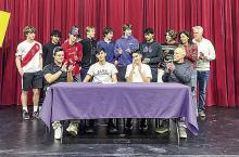 _ Leland senior Agustin Creamer (middle-left) receives a round of applause for his commitment to Alma College last week. Courtesy photo