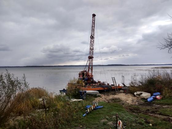 The barge, currently situated partly on state-owned Lake Michigan bottomlands and partly on private land north of Suttons Bay, was towed ashore last year following the issuance of seven criminal charges against Balcom in June.