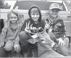 Owen Noonan holds the rack of the eight-point buck he shot Sunday morning, flanked by his sister Ivy, 5, and cousin Eli, 9. Courtesy photo