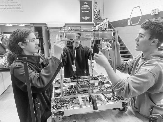Suttons Bay Norsemen robotics team members (from left to right) Casey Porter, Dean Hulett, and Jacob Gulley, are pictured assembling their robot. Courtesy photos