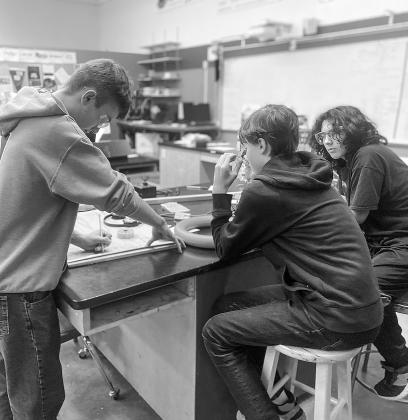 From left to right: Jacob Gulley, Koen Kruk, and James Miller are pictured in mid-design during a recent robotics practice at Suttons Bay Public School.