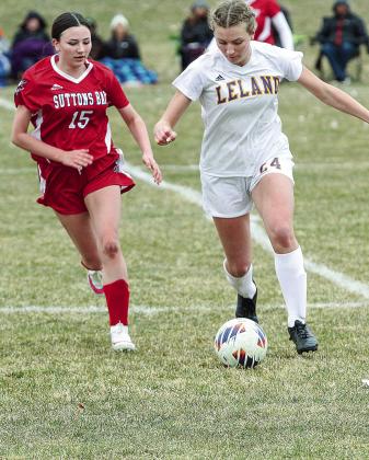 Suttons Bay freshman Megan Lint and Leland freshman Ariah Amin battle for possession during the first girls soccer game of the season last week.