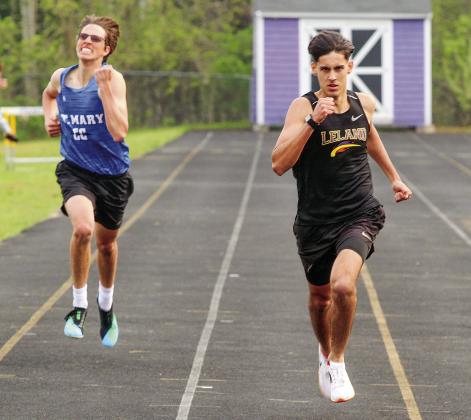 Leland senior Agustin Ceamer (right) and Lake Leelanau St. Mary sophomore Oliver Mitchell race in the 400meter run on Monday.