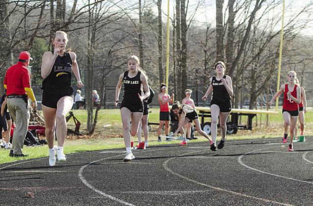 Leland junior Elysa Atha storms out of the blocks during a 200-meter sprint alongside Glen Lake’s Piper Briggs and Natalie Masse. Enterprise photo by Brian Freiberger