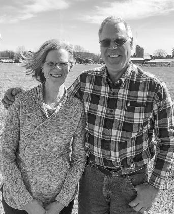 Cathy and Terry Lautner, with their dairy farm in the background, will be feted this week by the Michigan Milk Producers Association. Enterprise photos by Alan Campbell