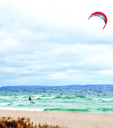 A hardy kite surfer braves 21 mph winds in chilly Sleeping Bear Bay. Photo courtesy of Phil Waldeck