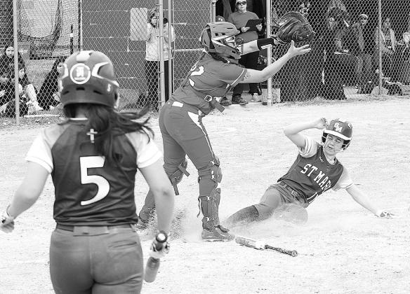 Lake Leelanau St. Mary freshman Lydia Bramer slides into home base during a 16-0 win over Suttons Bay on Tuesday. Enterprise photo by Brian Freiberger