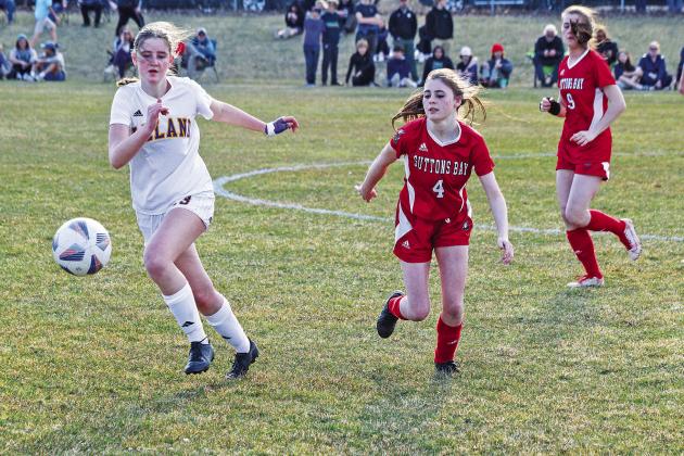 Leland senior Olive Ryder and Suttons Bay senior Lauren Lint compete during the 2023 season. Enterprise photo by Brian Freiberger
