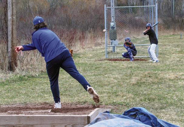 Suttons Bay’s Anthony Oskaboose batting (right) and catcher Gavin Schichtel (left) practice during spring ball Monday. Enterprise photo by Brian Freiberger