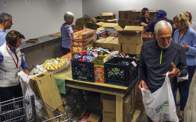 Leelanau Christian Neighbor volunteers packed 400 bags for the summer migrant school this week. Volunteers will also pack 60 boxes of food for 12 weeks this summer for Suttons Bay and Glen Lake Schools and Parenting Communities. Enterprise photo by Brian Freiberger