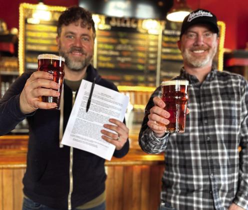 The Mitten Brewing Company owners Chris Andrus (at left) and Max Trierweiler (right) are pictured at their Northport location on Tuesday after securing a long-term lease with Three Rivers Properties. The five year lease with a five year renewal term helps ensure that The Mitten’s “up north” home is here to stay for the forseeable future. Courtesy photo