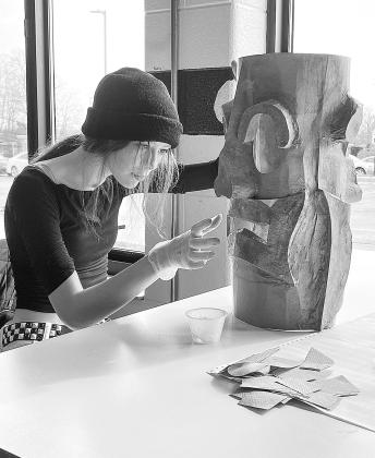 Northport Public School sophomore Valerie Glidden is pictured working on her sculpture at school which will be featured in the “J is for the Juxtaposition” student art exhibition on display next Thursday. Photo courtesy of Jenny Evans