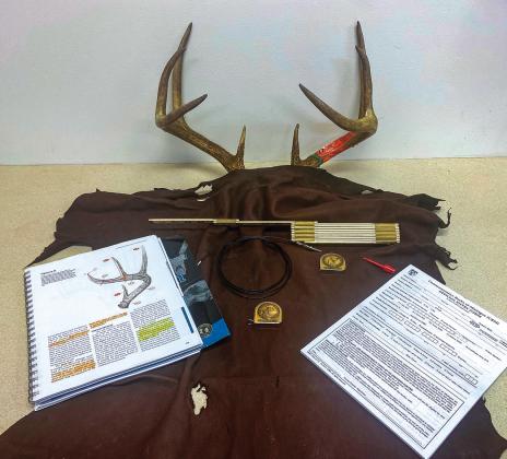 Some of the tools of the trade used by Travis Nelson, an official scorer for Commemorative Bucks of Michigan. Enterprise photo by Alan Campbell