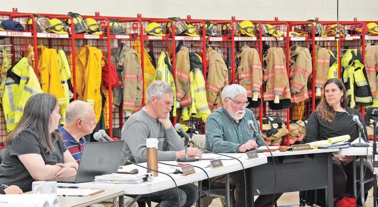 Members and staff of the Elmwood Township Planning Commission conduct a public hearing in the township fire hall on March 22 to accommodate a crowd of about 100 people who attended. Planners will meet again on April 11 in the fire hall to discuss the same subject -- a proposed “wellness resort” -- that is also likely to draw a large crowd. Enterprise photo by Eric Carlson