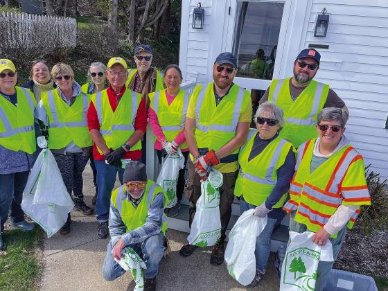 A dozen volunteers showed up last week to clean up the stretch of M-22 that includes Omena. Hallstedt Homestead Cherries of Northport has adopted it as part of the Adopt-A-Highway program. Pictured, from left to right, are Kathy Wessell, Marsha Buehler, Paula Peterson, Ann Julien, Ty Wessell, Doug Julien, Mary Robertson, Zach Bennet, Sam Reese, Jane Gale, and Sarah Hallstedt, with Dick McCulloch kneeling in front. Phil Hallstedt took the picture.
