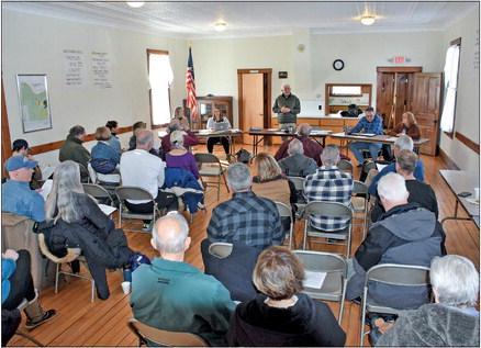 Cleveland Township Supervisor Tim Stein, standing center, addresses residents attending the township’s annual meeting Saturday. The supervisor is flanked by, from left, treasurer Angie Diotte and clerk Tanelle Budd, and trustees Todd and Jan Nowak. Enterprise photo by Eric Carlson