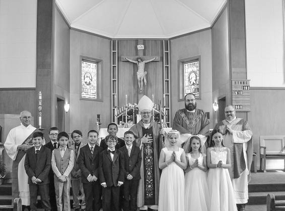 Students at St. Mary School recently received the sacraments of First Communion and Confirmation. Sacraments are outward signs of inward grace, instituted by Christ. Presiding over the ceremony is Deacon Martin Korson, Bishop Jeffery Walsh, Father Ben Martin and Father Ben Rexroat. Courtesy photo