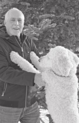 Glen Arbor resident Bob Jones having fun in the snow with his dog, Princess. Enterprise photo by Brian Freiberger