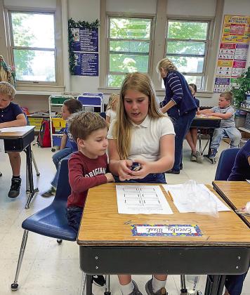Eagles Nest students, including Ellias West, left, look forward to once-a-month visits with their fourth grade “buddies.” Ellias enjoys learning from his sister, Everly. Enterprise photo by Alan Campbell