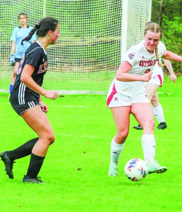 Suttons Bay defender Jacqueline Hearne and Leland attacker Willa Murray battle for possession in a Northwest Conference game on Monday against the two rivals. Enterprise photos by Brian Freiberger