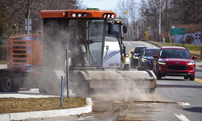 Snow plowing this week gave way to street sweeping as Leelanau County Road Commission workers and equipment begin clearing away a winter’s-worth of sand and grime from M-22 in downtown Suttons Bay on Monday morning. Enterprise photo by Eric Carlson