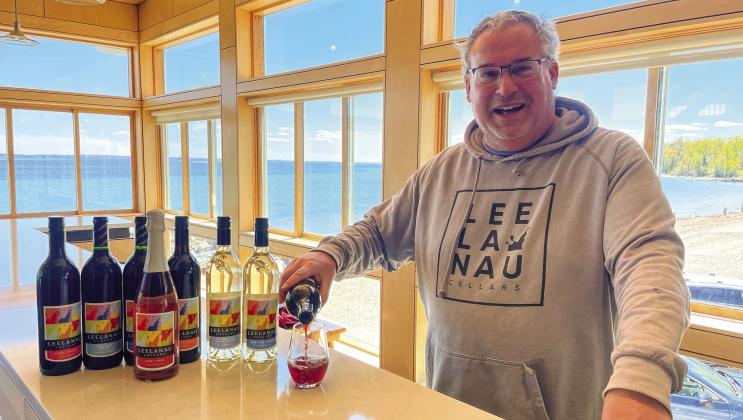 Leelanau Cellars President Bob Jacobson pours cheers to 50 years of business on the Leelanau Peninsula at their Omena tasting room. Enterprise photo by Brian Freiberger