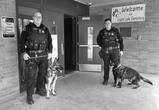 Deputies Jordan Strope and Cameron Drzewiecki and their respective K-9 companions, Keno and Klouse, trained last week at an empty school in Benzonia. Enterprise photo by Zachary Marano