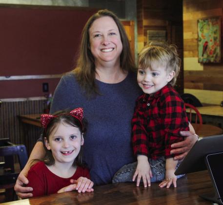 Cindy Henderson stands proudly with her grandchildren Lylah and Ollie after announcing the opening of Ollie R’s, a new burger joint in the same building that holds Lylah’s cafe. Enterprise photo by Brian Freiberger