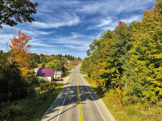Fall colors are expected to peak in Leelanau County in the next couple of weeks. Vibrant pops of color already are showing in leaves though, like in the trees here off County Rd. 633. Enterprise photo by Meakalia Previch-Liu