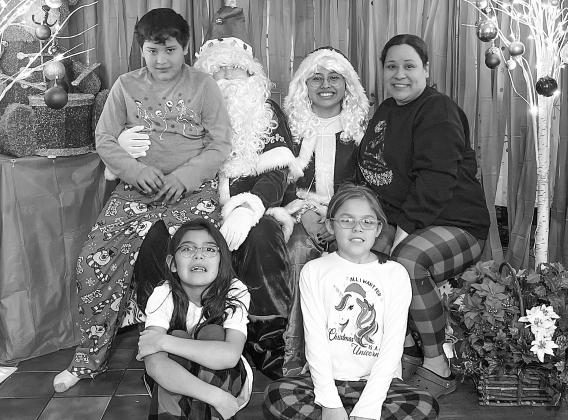 New Grand Traverse Band of Ottawa and Chippewa Indians’ (GTB) cultural department assistant/program director TaShena Sams is pictured with her three kids, Maiingan, Faith and Hope, at Christmas. Sams has been employed and working for the tribe for over 20 years now. Photo courtesy of TaShena Sams