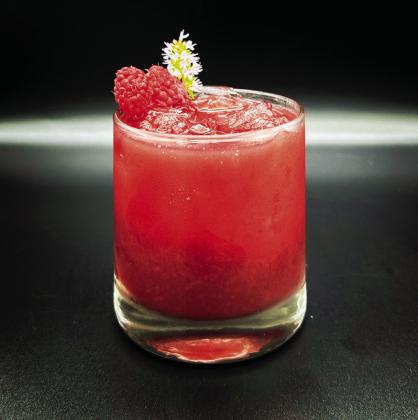 A drink called “Bohemian Raspody,” made with Audacia’s Ambrosia (floral berry) Elixir, is pictured. This particular drink also includes lemon juice, maple syrup, sparkling water, fresh raspberries, and mint leaves.