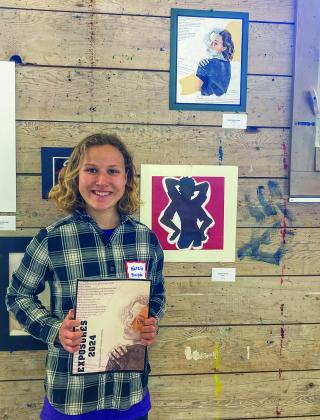 Leland freshman Natalie Burpee holds an issue of EXPOSURES 2024 during a student art show at the Old Art Building in Leland. Courtesy photo